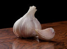Hardneck garlic bulb and clove on wood surface
